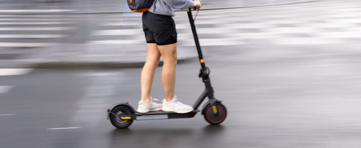 Person riding a scooter on a city street